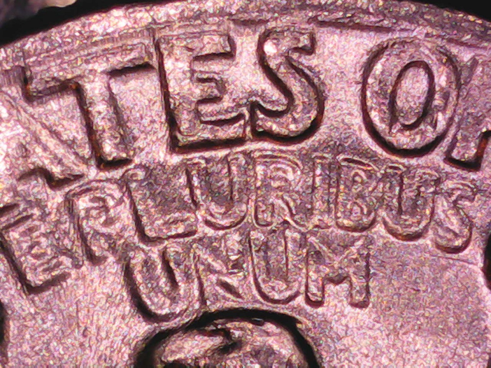 1954 quarter doubled die reverse error showing subtle doubling on E PLURIBUS UNUM reverse lettering under magnification